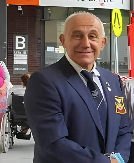 Dedicated AHEPA Victoria member in formal attire promoting Greek heritage and community involvement.