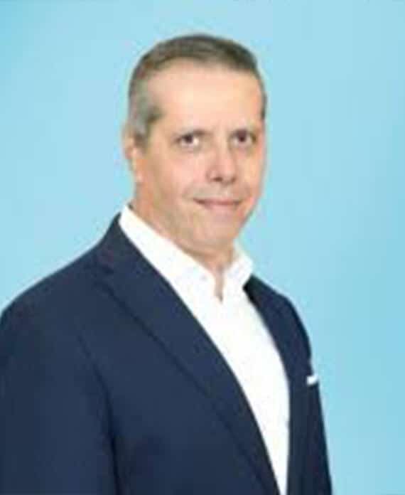 AHEPA Victoria community leader in formal suit, representing Greek-American heritage.